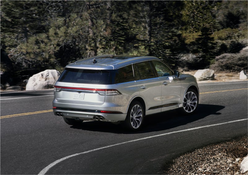 A 2023 Lincoln Aviator® Grand Touring model is shown being driven on a tight turn of a mountain road | Lincoln of Ramsey in Ramsey NJ