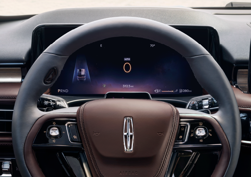 The steering wheel of 2025 Lincoln Aviator® SUV is shown with black and brown accents. | Lincoln of Ramsey in Ramsey NJ