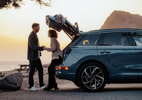 A couple share a moment together outside a 2025 Lincoln Corsair® SUV near the open liftgate. | Lincoln of Ramsey in Ramsey NJ