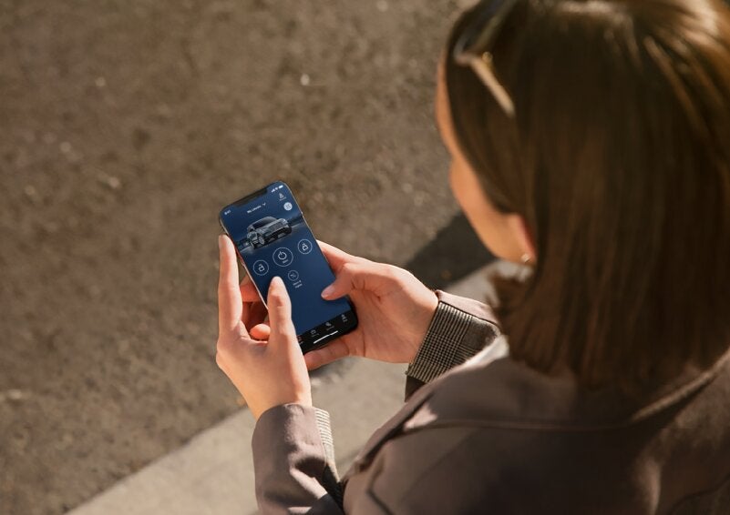 A person is shown interacting with a smartphone to connect to a Lincoln vehicle via the Lincoln Way® App. | Lincoln of Ramsey in Ramsey NJ