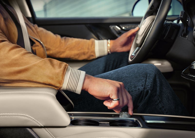 The driver of a 2024 Lincoln Corsair® SUV is shown selecting the drive mode. | Lincoln of Ramsey in Ramsey NJ