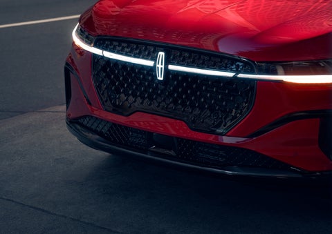 The available front LED light bar and center Lincoln Star logo glow at dusk. | Lincoln of Ramsey in Ramsey NJ