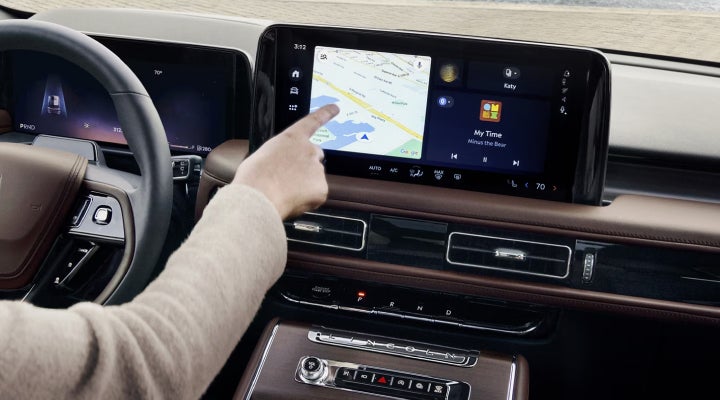 A person is tapping the center display touchscreen of a 2026 Lincoln Aviator® SUV. | Lincoln of Ramsey in Ramsey NJ