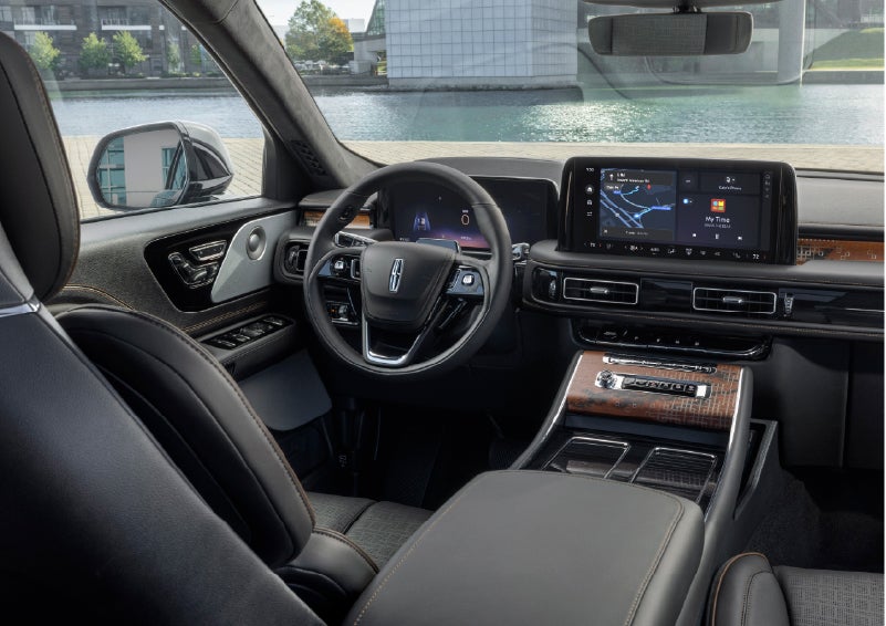 The interior of the 2026 Lincoln Aviator® SUV is shown parked with a view of a harbor through the windshield. | Lincoln of Ramsey in Ramsey NJ