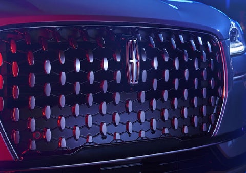 The grille of a 2025 Lincoln Corsair&reg; SUV reflects neon light at night. | Lincoln of Ramsey in Ramsey NJ