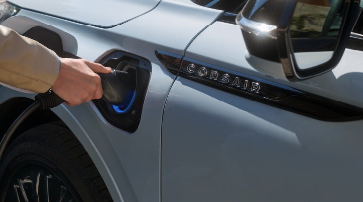 A hand is plugging in a 2026 Lincoln Corsair® Grand Touring Plug-in Hybrid SUV. | Lincoln of Ramsey in Ramsey NJ