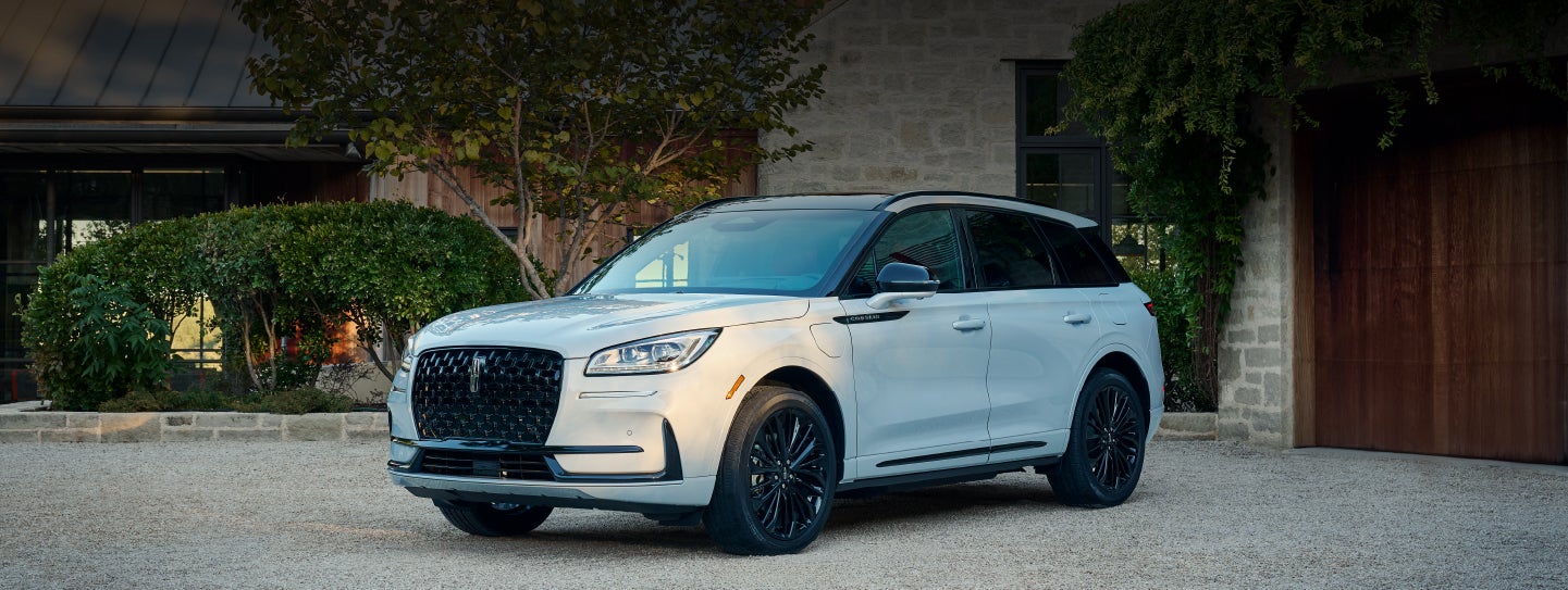 A 2026 Lincoln Corsair® SUV is parked in front off a luxury home. | Lincoln of Ramsey in Ramsey NJ
