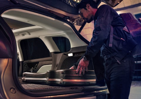 A man is shown loading cargo into the rear of a 2026 Lincoln Corsair® SUV with the second-row seats folded flat. | Lincoln of Ramsey in Ramsey NJ
