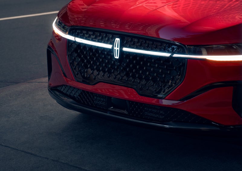 The available front LED light bar and center Lincoln Star logo glow at dusk. | Lincoln of Ramsey in Ramsey NJ