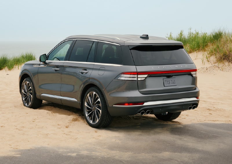 A 2027 Lincoln Aviator® SUV is parked next to sand dunes. | Lincoln of Ramsey in Ramsey NJ