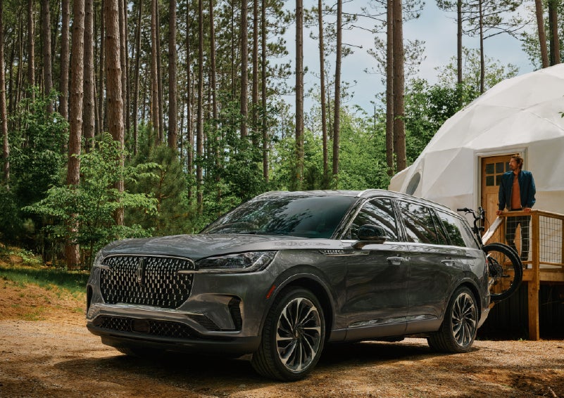 A 2027 Lincoln Aviator® is parked next to a high end glamping site. | Lincoln of Ramsey in Ramsey NJ