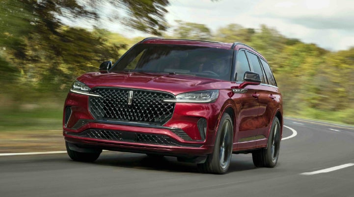 A 2027 Lincoln Aviator® SUV is being driven on a country road | Lincoln of Ramsey in Ramsey NJ