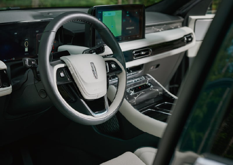 The leather-trimmed steering wheel of a 2027 Lincoln Aviator® Black Label™ SUV. | Lincoln of Ramsey in Ramsey NJ