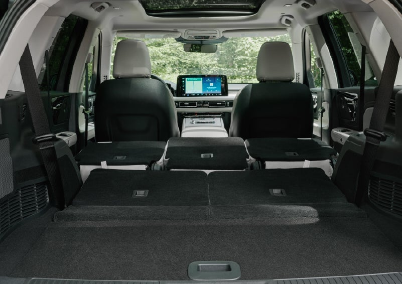 A rear to front view of the interior of a 2027 Lincoln Aviator® Black Label™ SUV shows the third and second rows folded flat | Lincoln of Ramsey in Ramsey NJ