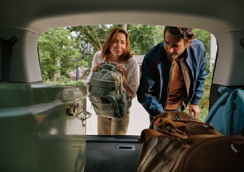 A couple loads luggage into the rear of a 2027 Lincoln Aviator® Black Label™ SUV..e 202 | Lincoln of Ramsey in Ramsey NJ