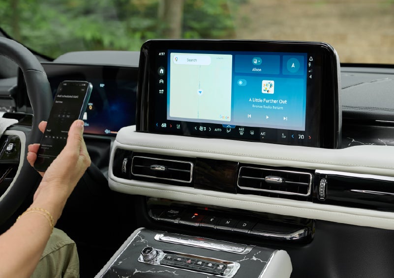 A person pairs thier phone with the center touchscreen of a 2027 Lincoln Aviator® Black Label™ SUV | Lincoln of Ramsey in Ramsey NJ