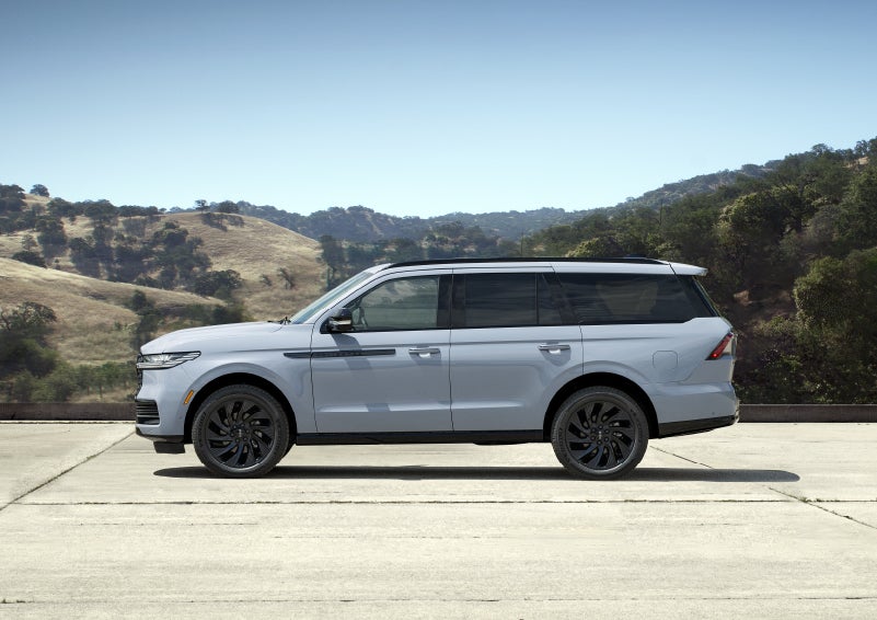 A 2027 Lincoln Navigator® SUV is parked at a scenic mountain overlook.