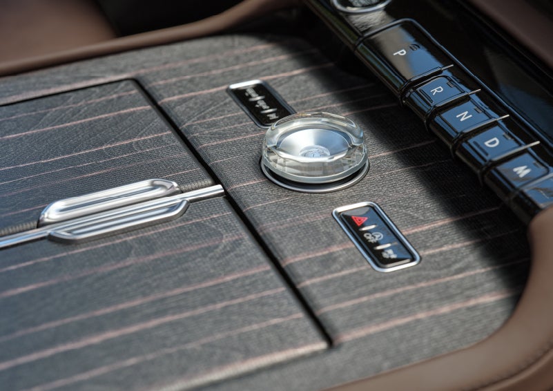 Real wood inlays on the center front console add dazzling detail to a 2027 Lincoln Navigator® Black Label™ SUV.